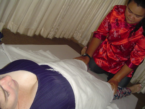 A traditional Thai massage being given on a spa bed