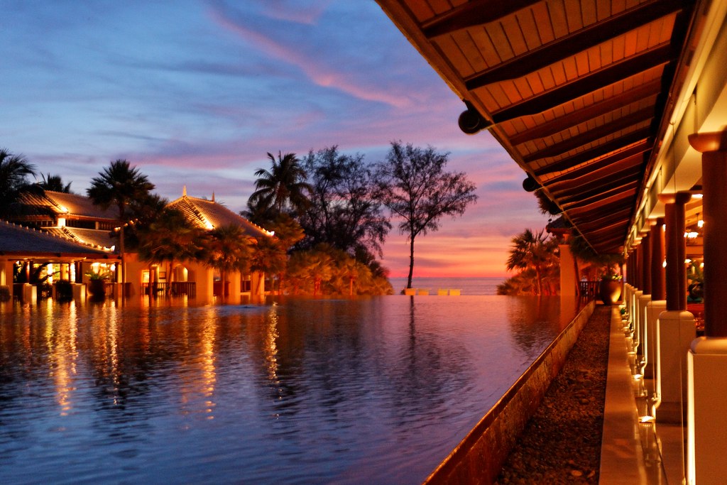 Sunset over the water beside an open-air Phuket restaurant at dusk