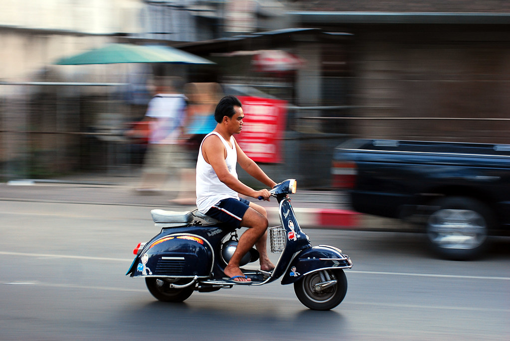 A rider on a scooter in Phuket, where road safety matters for visitors
