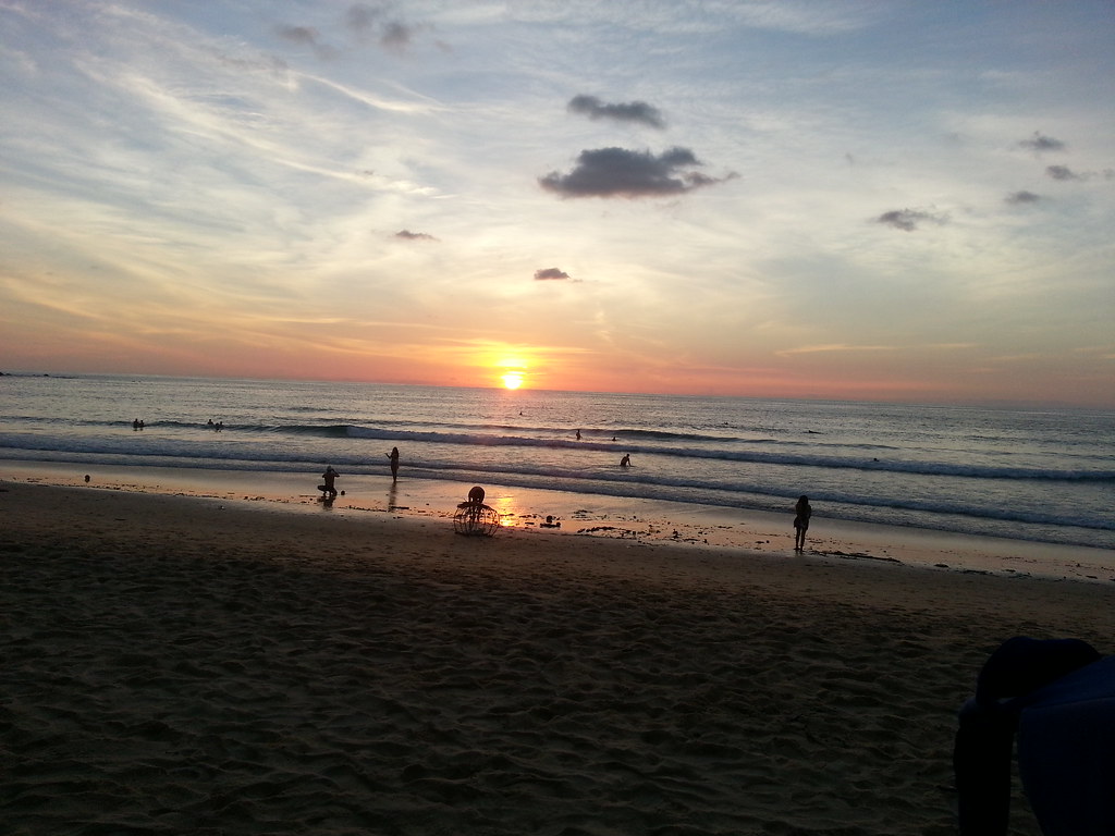 Wide view of Karon Beach at sunset with soft evening colours over the sea