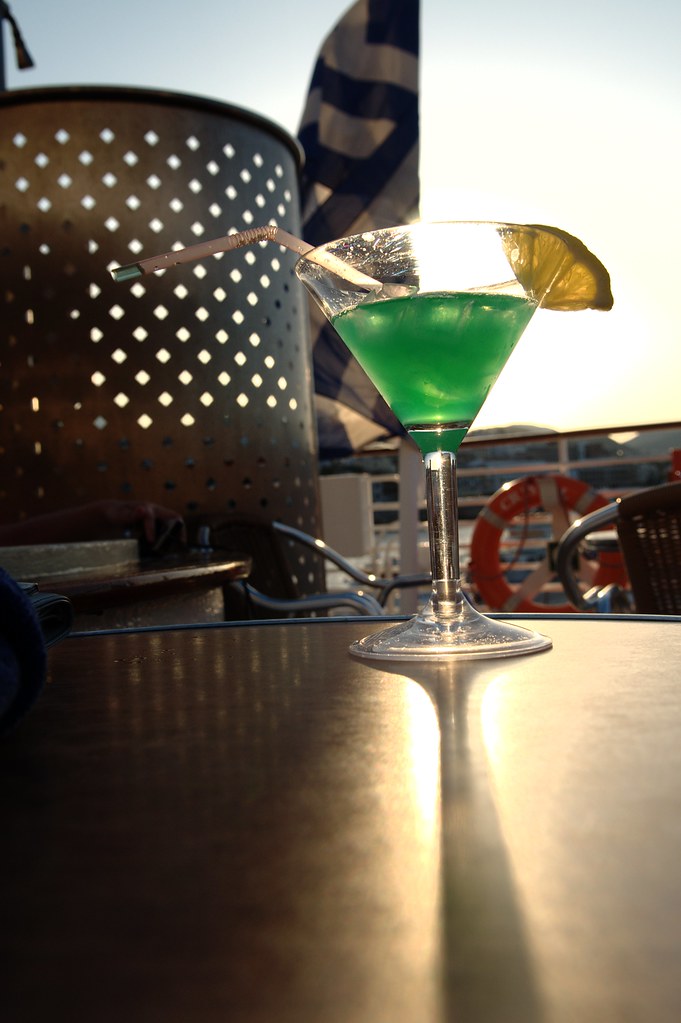 A cocktail served on board beside a life ring for sunset drinks at sea