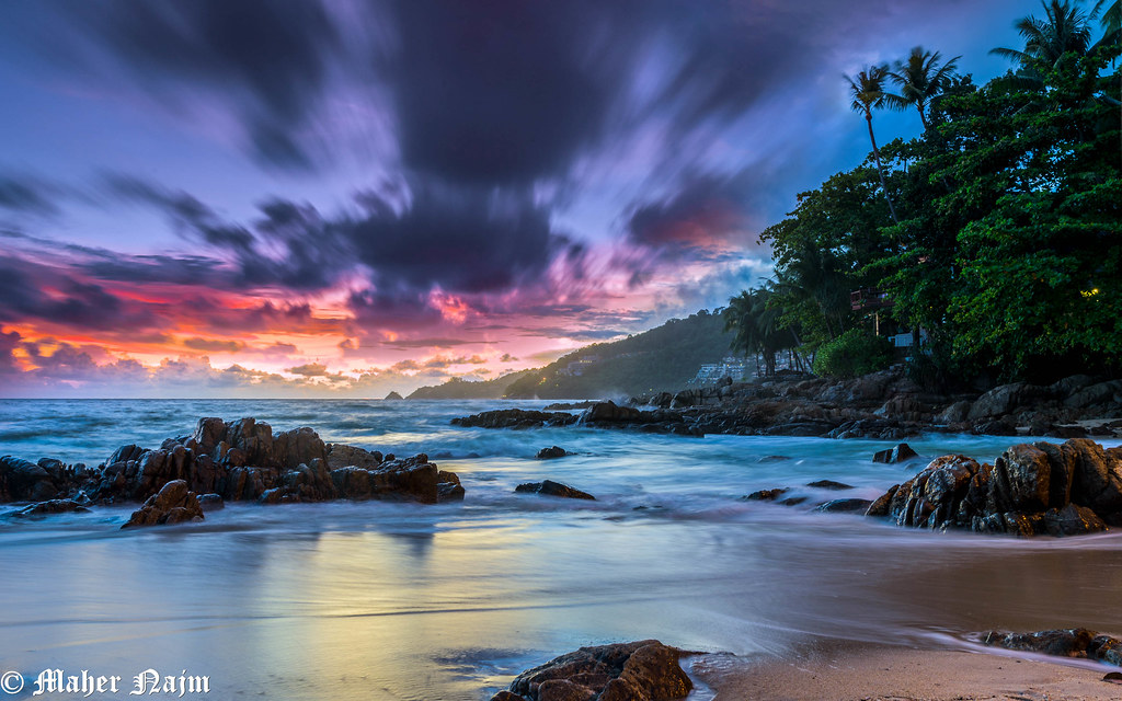 A colourful sunset over the rocky Phuket coastline